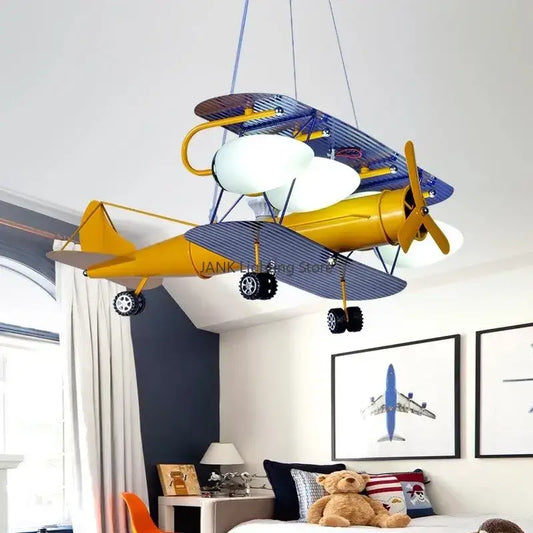 Decorbites™ airplane kids led chandelier shaped like a whimsical yellow and blue biplane with striped wings and white globe bulbs