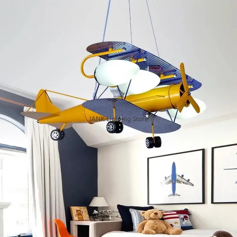 Decorbites™ airplane kids led chandelier shaped like a whimsical yellow and blue biplane with striped wings and white globe bulbs