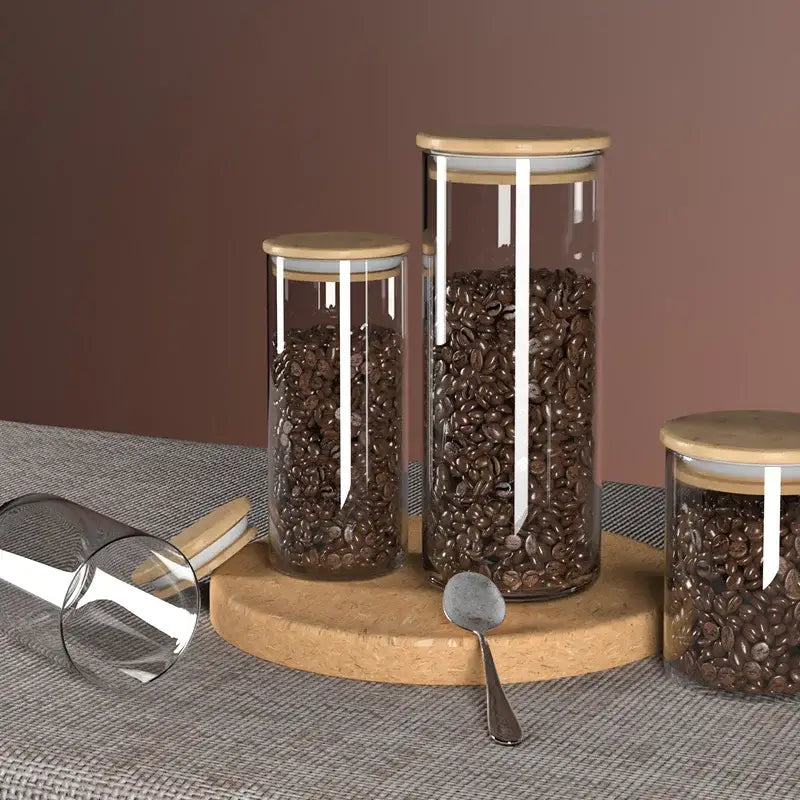 Decorbites™ airtight glass coffee bean storage jars with bamboo lids and white silicone seals on cork board display