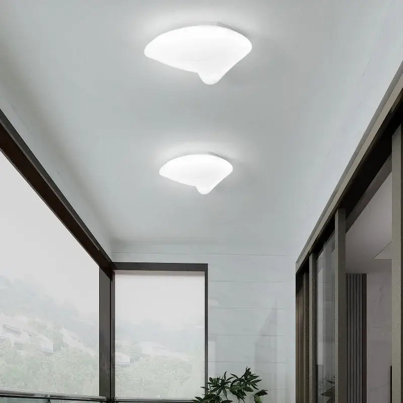 Two modern white cloud-shaped aisal flower ceiling lights with smooth diffused glow and remote dimming feature