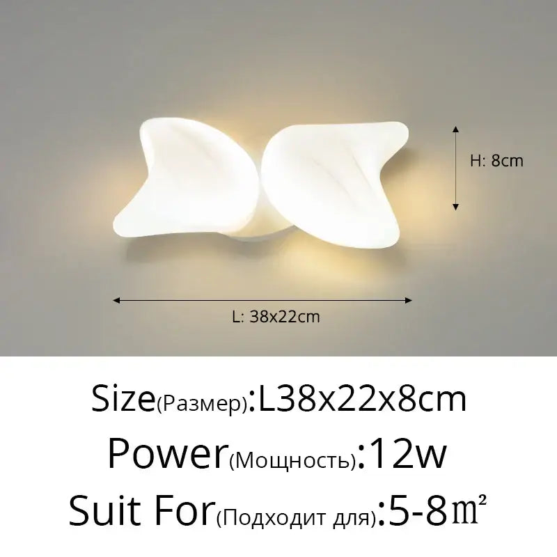 White sculpted butterfly-shaped wall sconce with glossy finish complements aisal flower ceiling chandelier decorbites