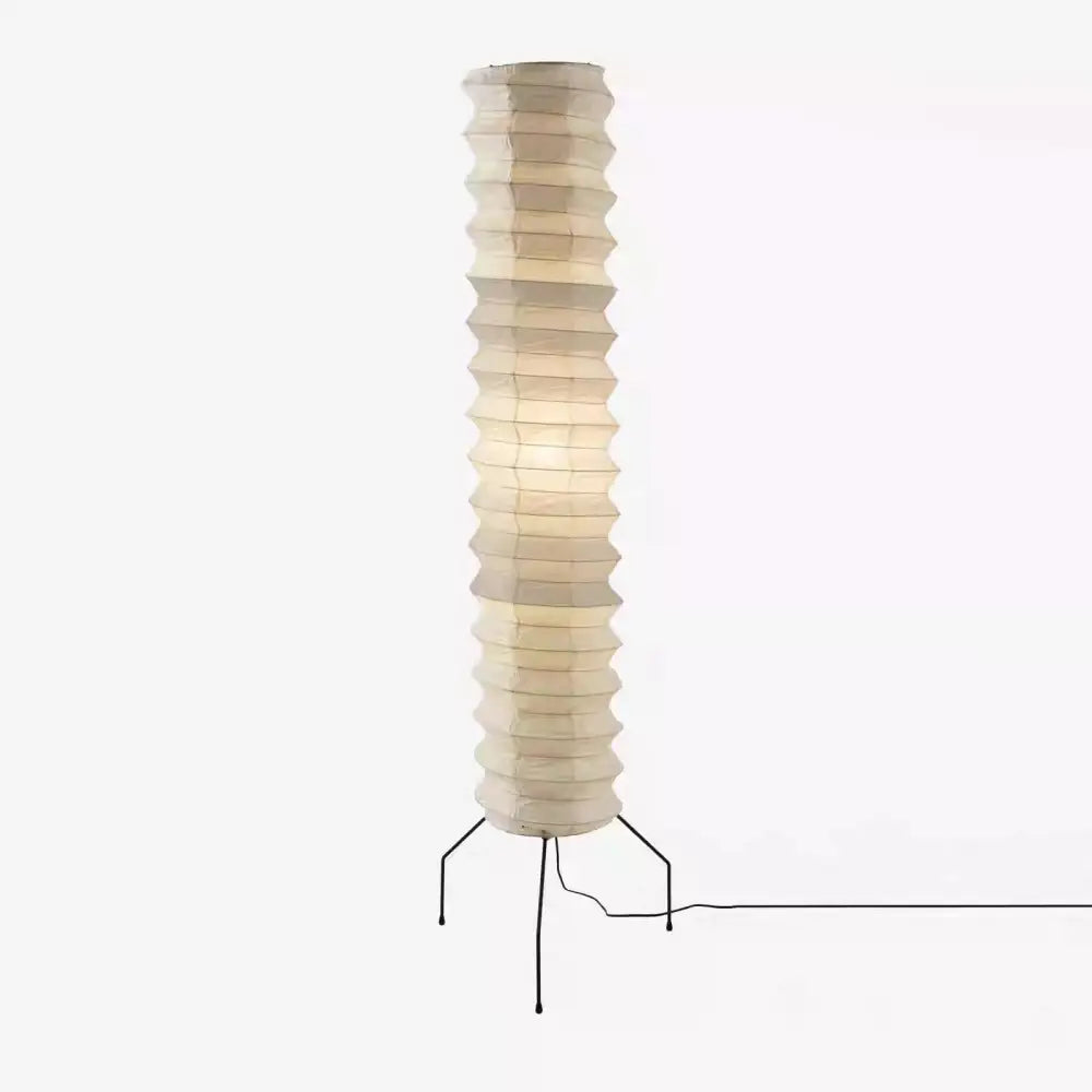 Tall cream-colored akari noguchi floor lamp with segmented rice paper shade and black metal tripod base for living room decor