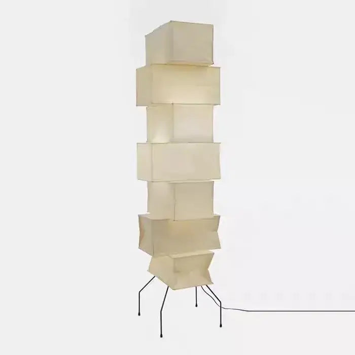 Cream-colored akari noguchi floor lamp with stacked cube rice paper shade and thin black metal legs for living room decor