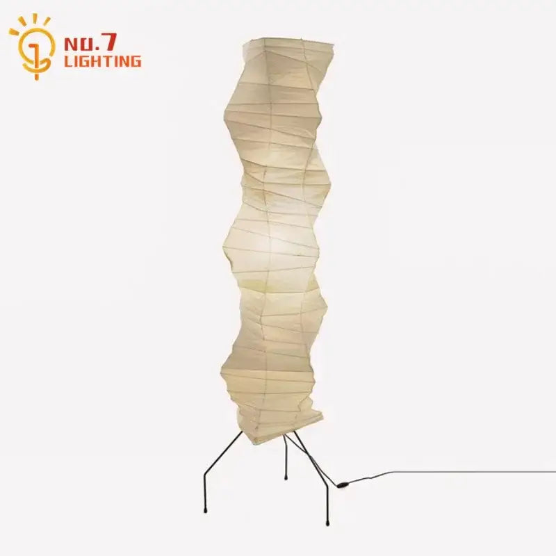 Cream-colored akari noguchi floor lamp with accordion rice paper shade and black metal tripod base for living room decor