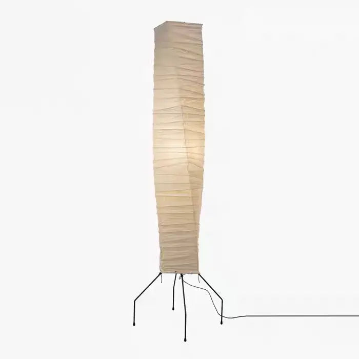Tall beige akari noguchi floor lamp with ribbed rice paper shade and black metal tripod base for living room decor