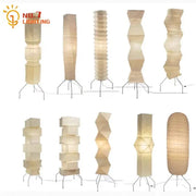 A collection of cream-colored akari noguchi floor lamps with geometric rice paper designs for elegant living room decor