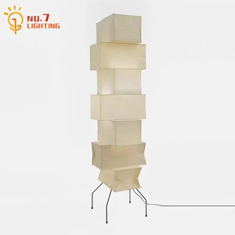 Cream-colored akari noguchi floor lamp with stacked cube rice paper shade and black metal legs for living room decor