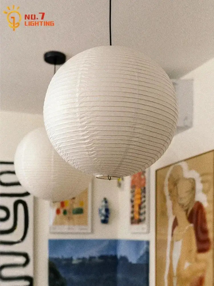 White spherical paper pendant light featuring akari noguchi led design for living room decorbites wabi-sabi style