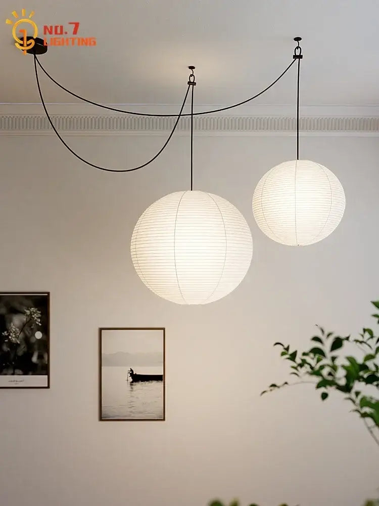 Two spherical white paper pendant lights by decorbites akari noguchi led hang from ceiling for living room decor