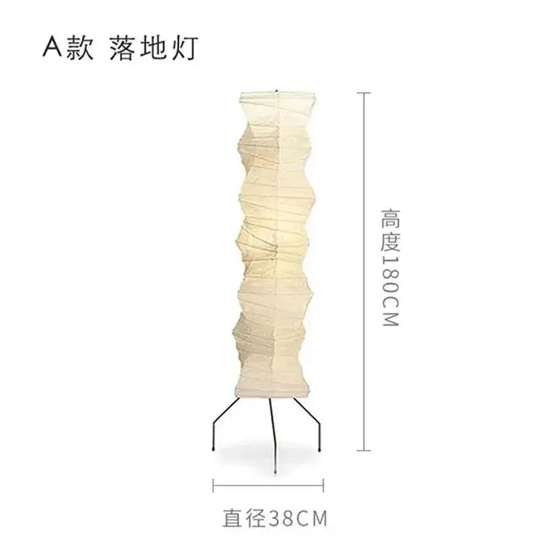 Cream-colored akari noguchi floor lamp with accordion folded rice paper shade and black metal tripod base for living room