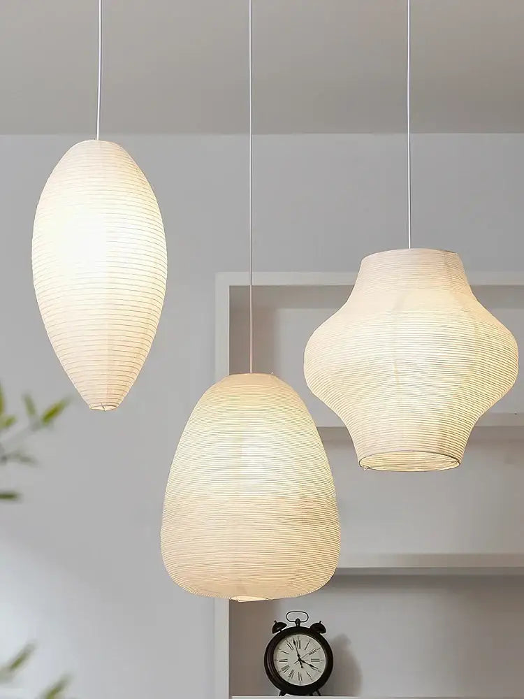 Three elegant off-white decorbites™ akari noguchi rice paper pendant lights with ribbed textures for bedroom or living room