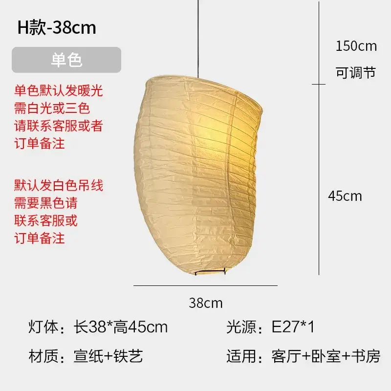 A warm beige rice paper pendant light with ribbed texture and iron frame hangs from adjustable white cord by DecorBites