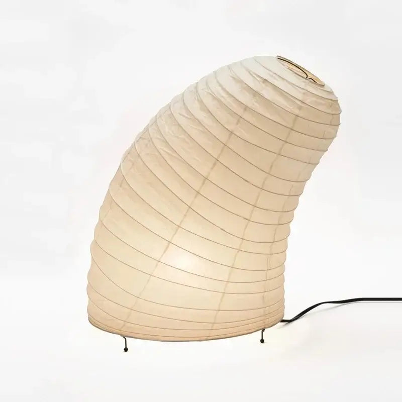 Beige akari noguchi rice paper table lamp with curved ribbed design and black metal legs for modern living room decor