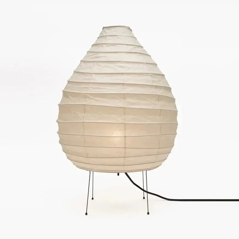 Cream-colored akari noguchi rice paper table lamp with pleated teardrop shade and slender black metal legs for living room