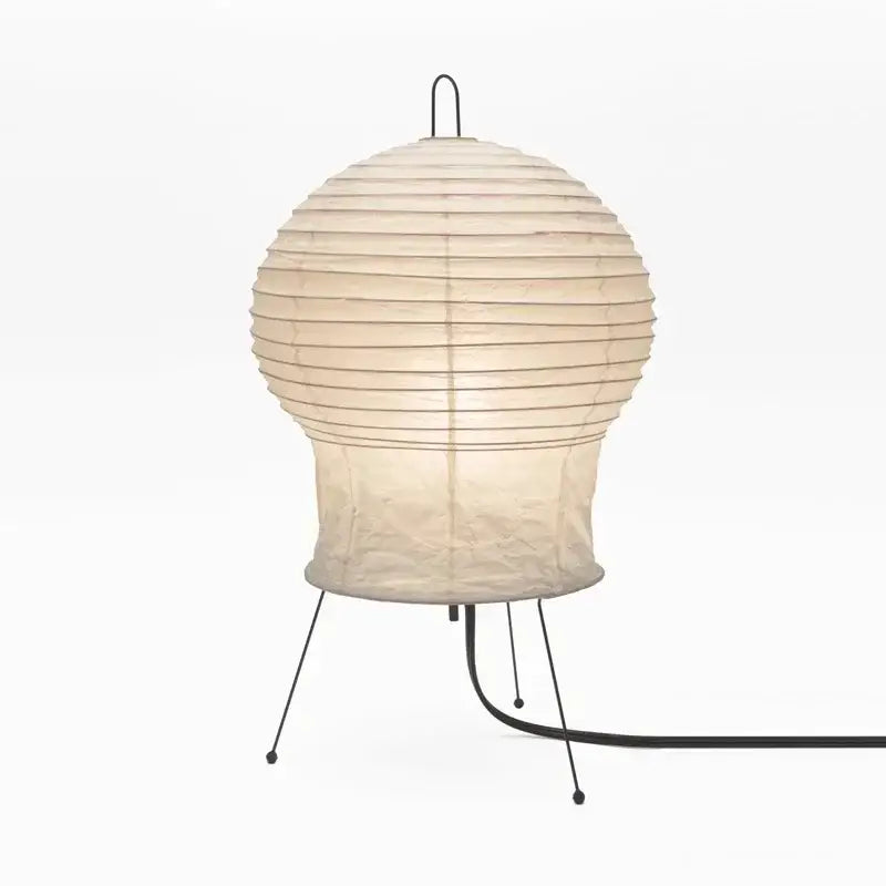 Cream-colored akari noguchi rice paper table lamp with black metal stand and cord for modern living room lighting