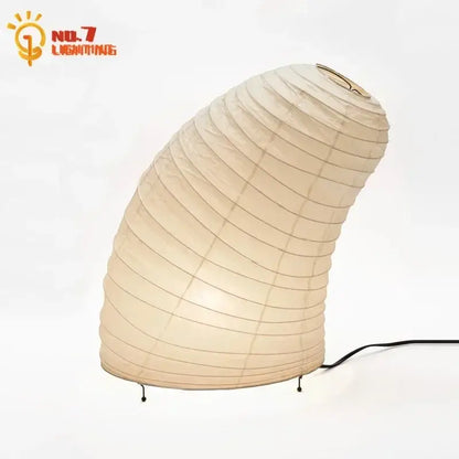 Cream-colored decorbites akari noguchi rice paper table lamp with curved design and black metal legs for living room