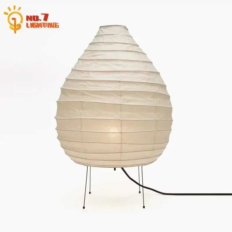 Cream-colored DecorBites akari noguchi rice paper table lamp with tiered teardrop shape and black metal legs for living room