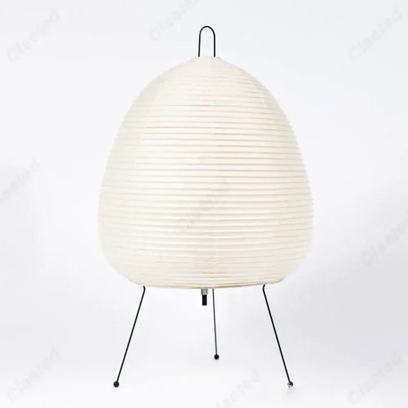 Off-white rice paper noguchi table lamp with ribbed texture and black metal tripod base for home decor