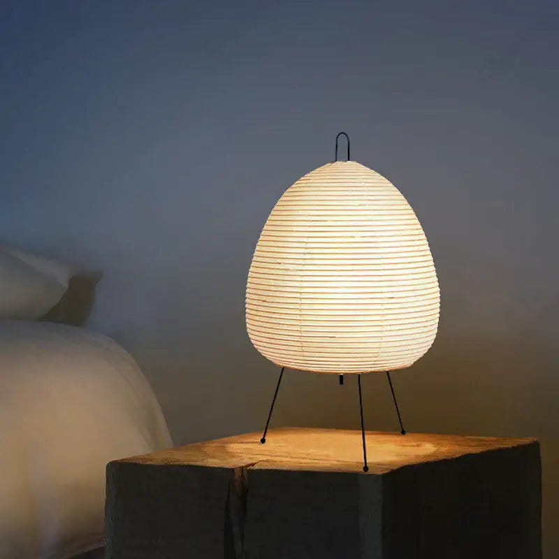 Elegant off-white DecorBites Akari Noguchi table lamp with rice paper shade, slender black metal legs, and curved handle for décor