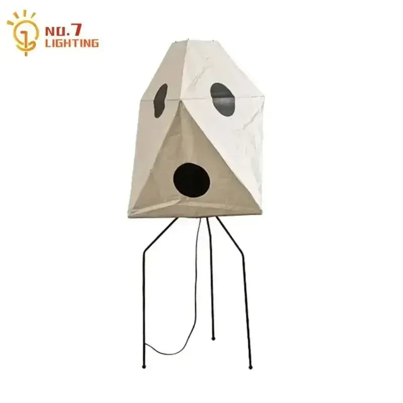 Beige geometric decorbites akari noguchi table lamp with black circular cutouts and slender metal stand for desk use