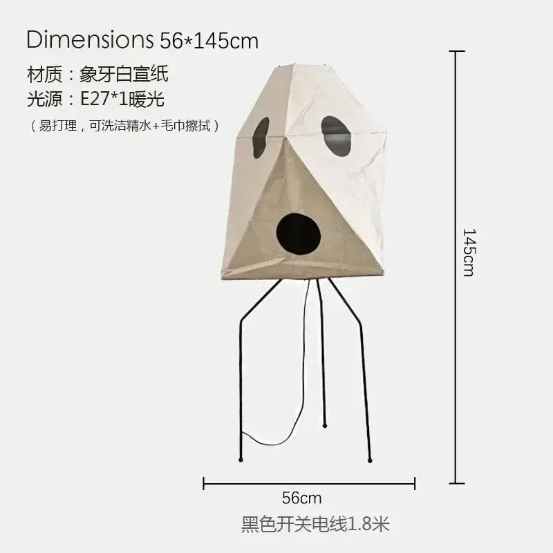 Beige rice paper akari noguchi table lamp with black circular cutouts and tripod base for versatile lighting