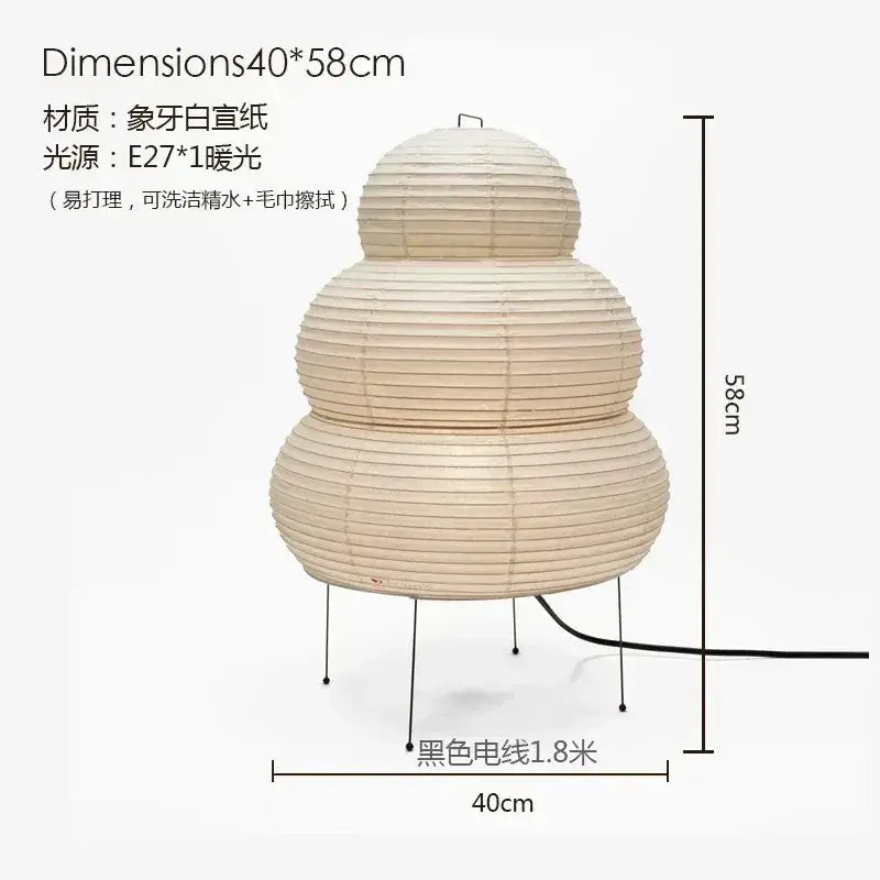 Beige three-tiered akari noguchi table lamp with rice paper shade and black metal legs for desk lighting