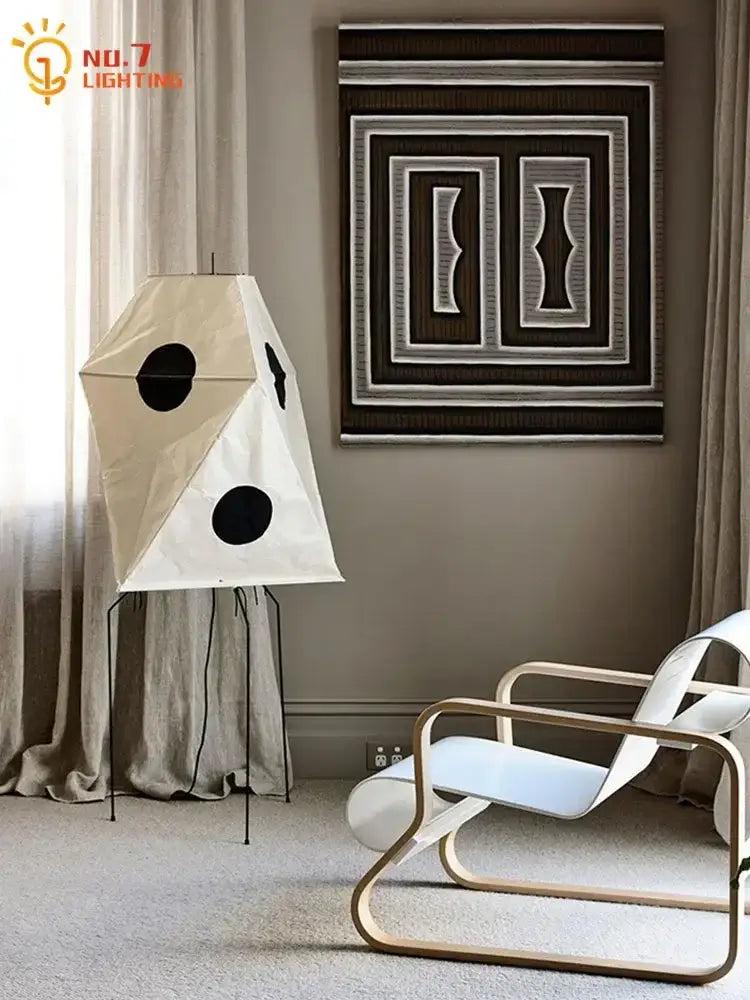 Cream-colored akari rice paper floor light with black circular accents and minimalist metal stand vintage style