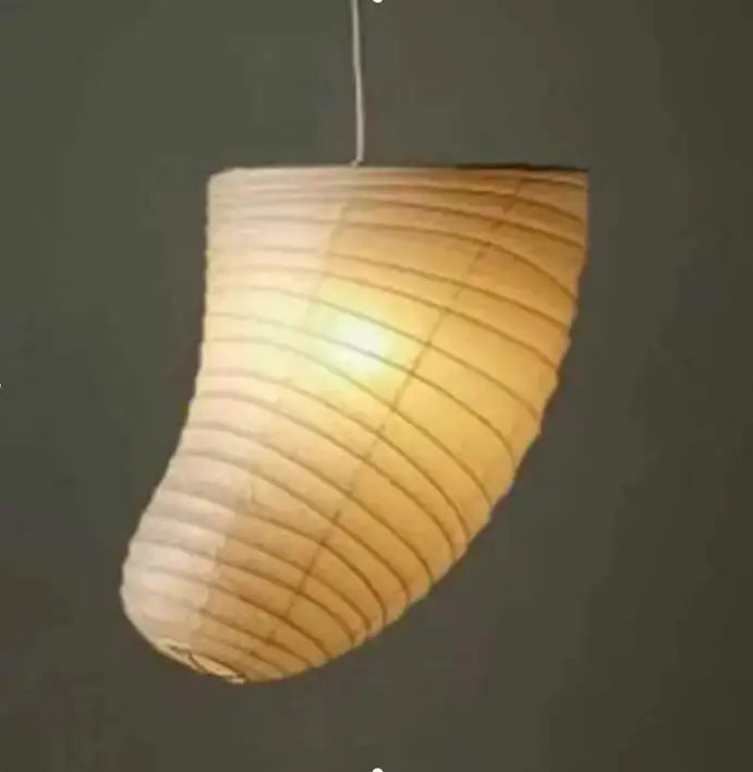 A warm glowing natural beige akari rice paper pendant lamp with curved ribbed design for living room and bedroom lighting