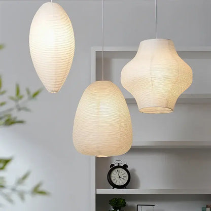 Three elegant off-white akari rice paper pendant lamps with ribbed textures and soft glow for living room lighting