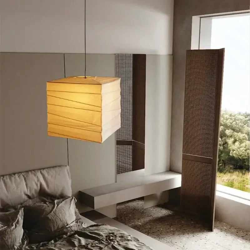 Warm-toned square akari rice paper pendant lamp with horizontal pleats for living room or bedroom lighting