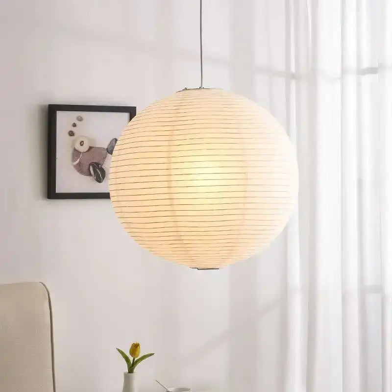 Warmly glowing white akari rice paper pendant light handwoven spherical paper lantern for home décor by decorbites