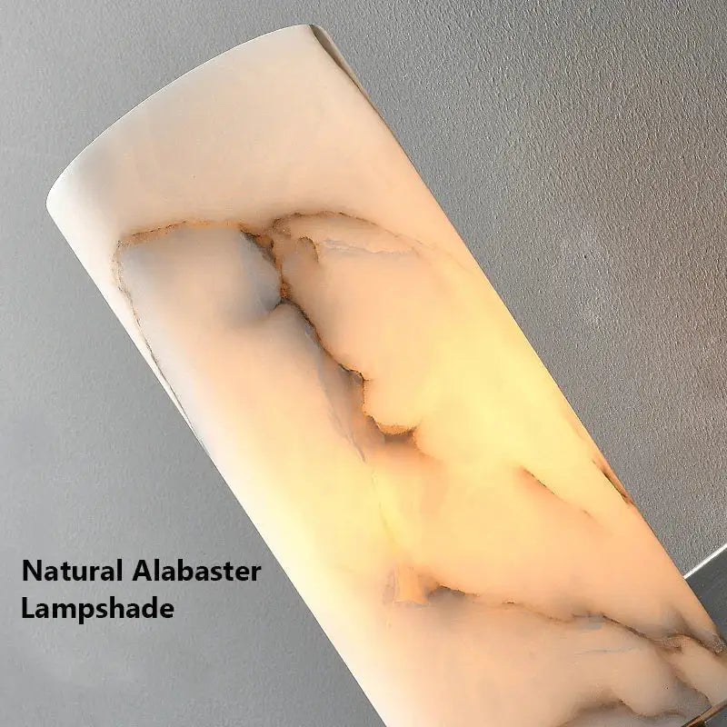 DecorBites™ alabaster copper wall lamp with a sleek curved ivory alabaster shade featuring warm amber veining and LED light