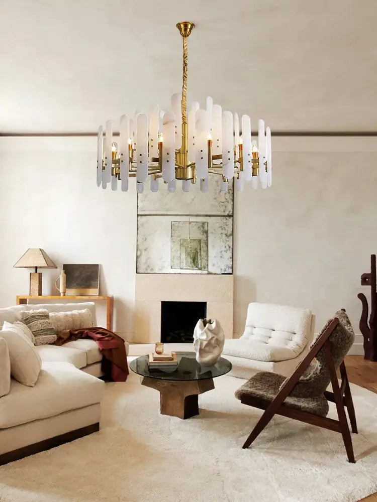 A modern alabaster gold chrome chandelier suspension with a gold-toned frame and translucent white glass rods for living room