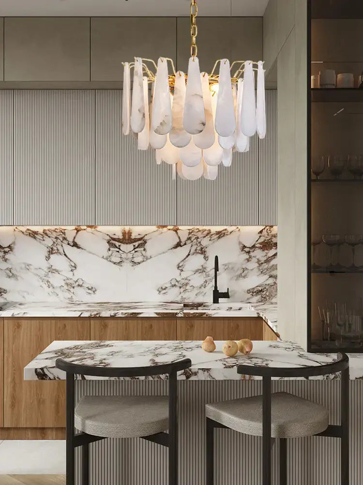 Modern alabaster lustre led chandelier with gold chain and white marble teardrop shades above kitchen island