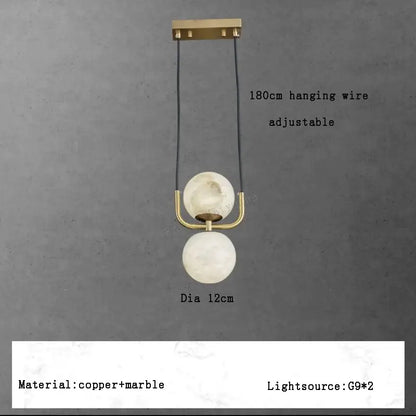 Modern two-tiered pendant lights with polished brass hardware and off-white alabaster marble spheres for luxury décor