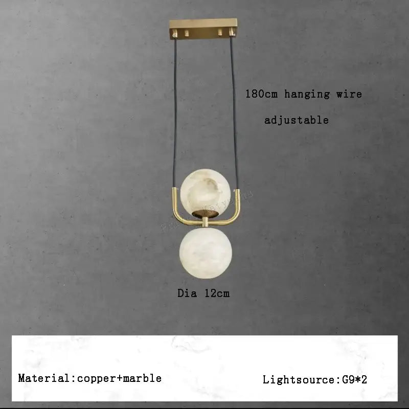 Modern two-tiered pendant lights with polished brass hardware and off-white alabaster marble spheres for luxury décor
