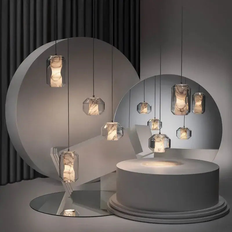 Modern geometric alabaster marble pendant lights with clear glass and warm interiors for luxury dining room décor