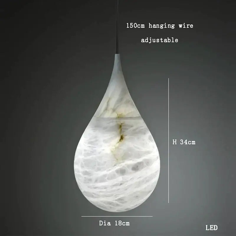 A sleek teardrop-shaped alabaster marble pendant light with white and gray marbled finish for luxury dining room decor