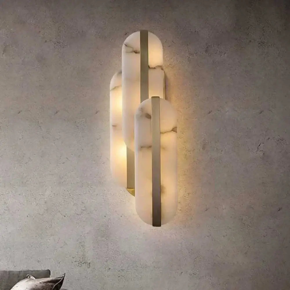 Modern alabaster moon oval wall lamp with three stacked marble panels and gold copper accents for indoor decor