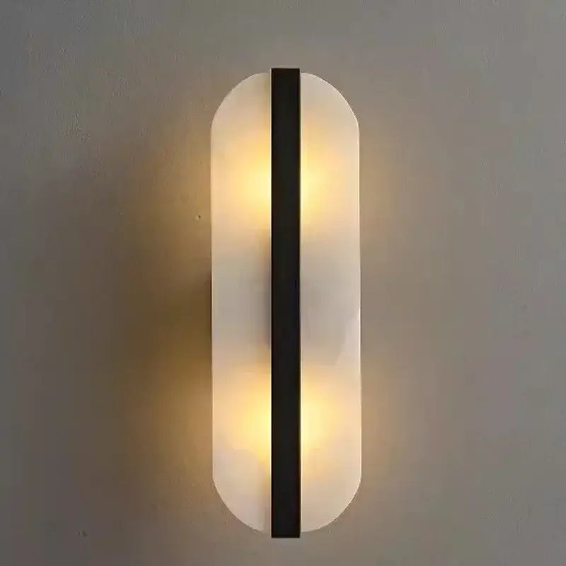 Modern minimalist wall lamp with alabaster oval marble body and black metal accent for indoor living room lighting