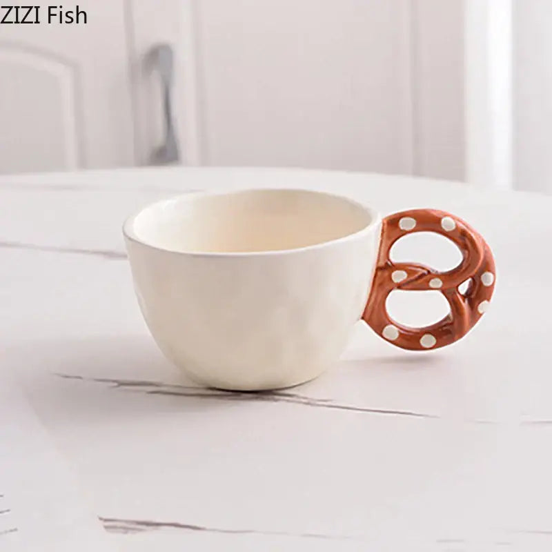 A white biscuit mug ceramic teacup with a brown pretzel-shaped handle featuring white polka dots from decorbites alkali water biscuit set