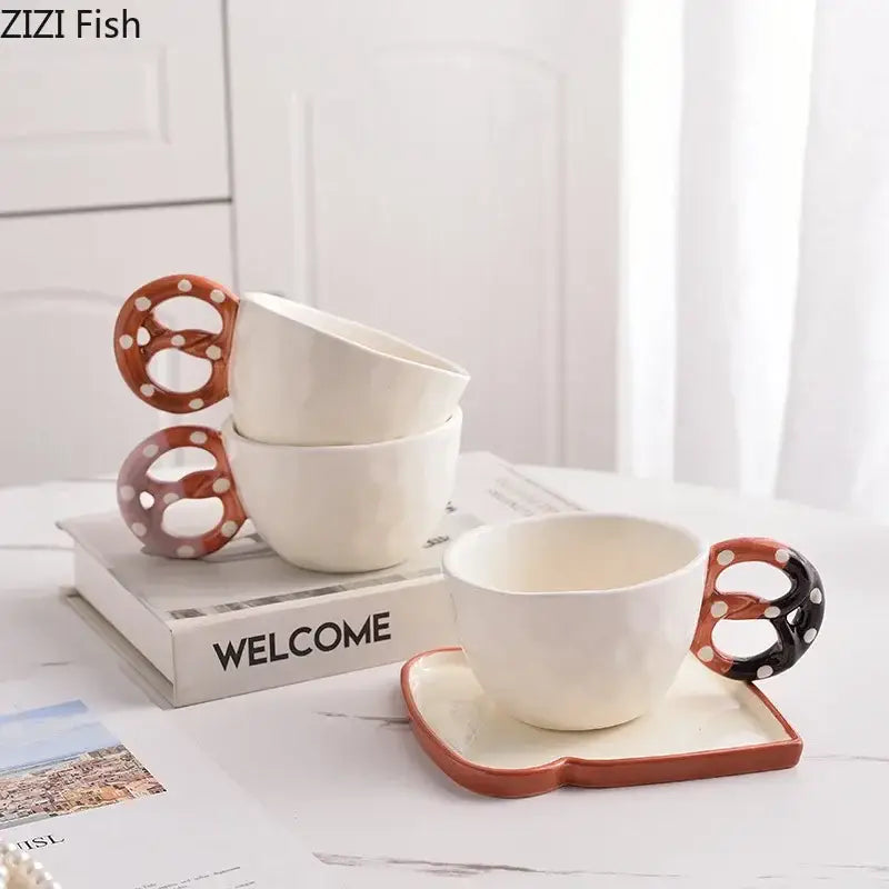 White ceramic alkali water biscuit mug with pretzel shaped handle in orange and black polka dots from decorbites mug set