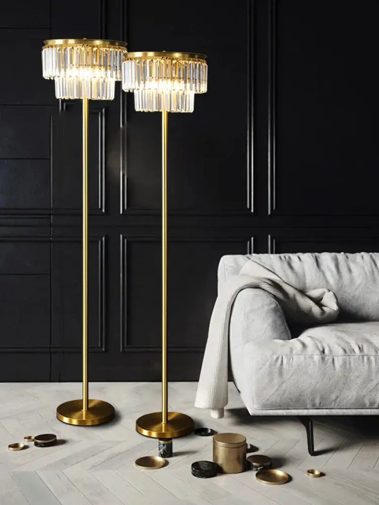 Two elegant gold brass crystal floor lamps with cascading chandeliers for luxury living room lighting by DecorBites
