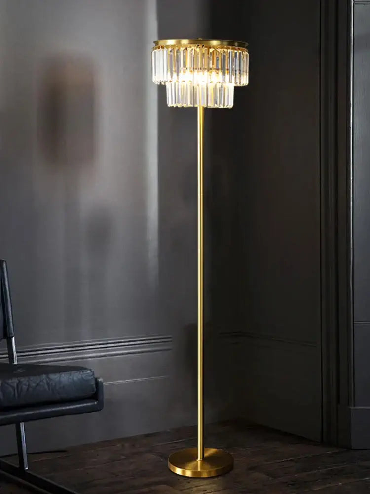 Gold-toned brass crystal floor lamp with tiered chandelier design for luxury living room lighting by DecorBites
