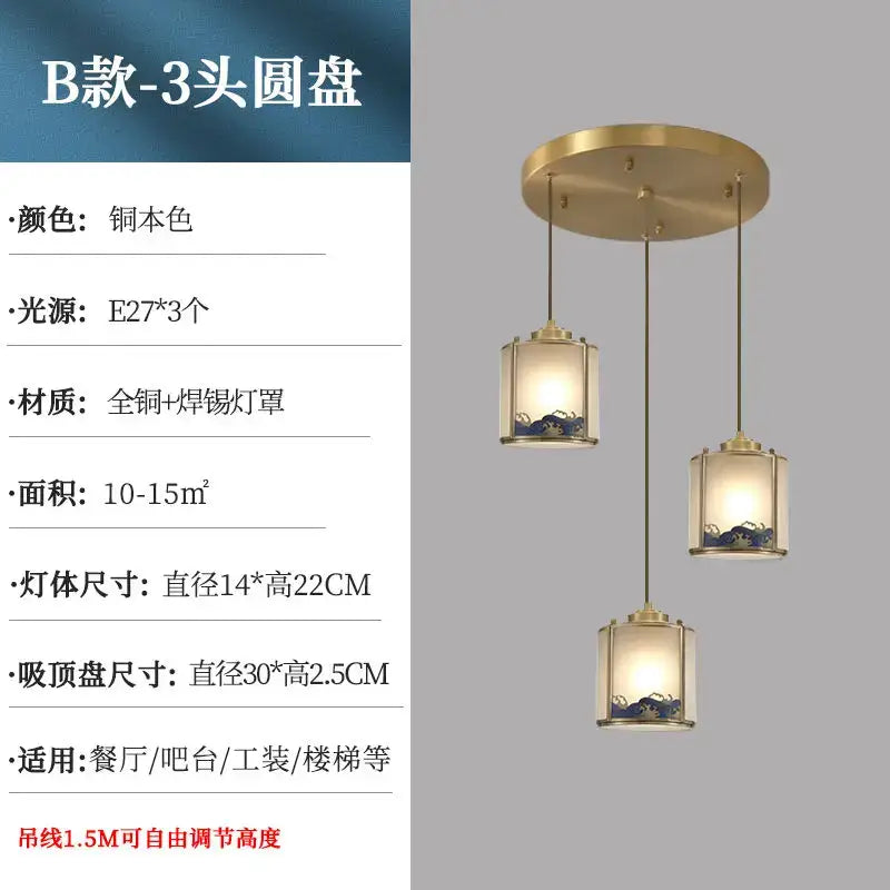 Brass-finished three-head pendant light with cylindrical glass shades and blue accents for copper entrance light and rotating staircase light
