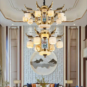 Golden copper jade chandelier with frosted glass lanterns and intricate antler-like metal arms for villa living room