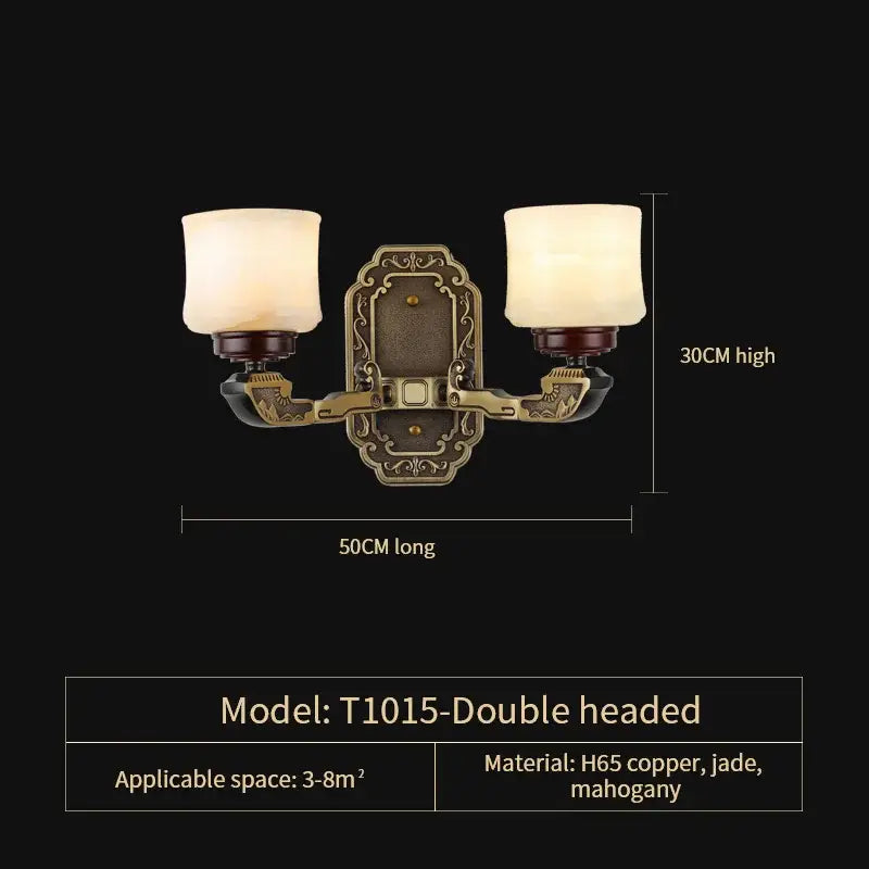 Antique brass-finished double-headed wall sconce with frosted glass shades and ornate details for luxury copper marble jade lighting