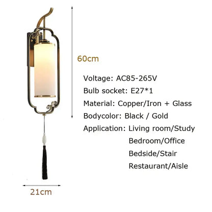 Elegant black and gold copper wall lamp with cylindrical frosted glass shade and decorative tassel for living room use