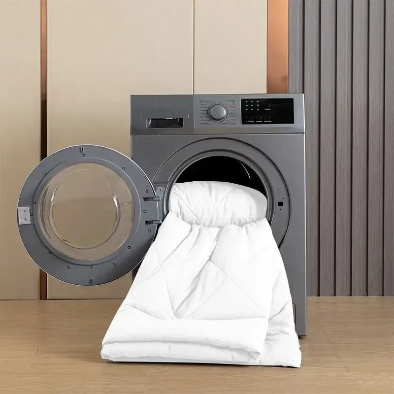 White quilted brushed duvet quilt partially inside a modern silver washing machine for all-season comfort