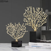 Golden alloy coral crafts with intricate branching on sleek black crystal base for stylish desktop decor